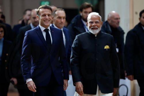 epa11888013 French President Emmanuel Macron (L) walks next to Indian Prime Minister Narendra Modi (R) prior to the plenary session during the Artificial Intelligence (AI) Action Summit at the Grand Palais in Paris, France, 11 February 2025. The summit takes place from 10 to 11 February.  EPA/MOHAMMED BADRA