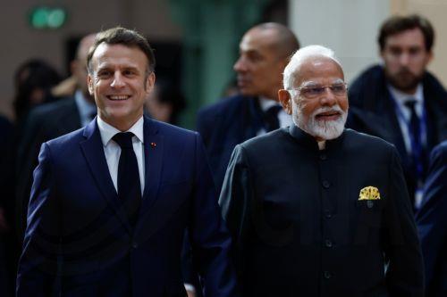 epaselect epa11888022 French President Emmanuel Macron (L) walks next to Indian Prime Minister Narendra Modi (R) prior to the plenary session during the Artificial Intelligence (AI) Action Summit at the Grand Palais in Paris, France, 11 February 2025. The summit takes place from 10 to 11 February.  EPA/MOHAMMED BADRA