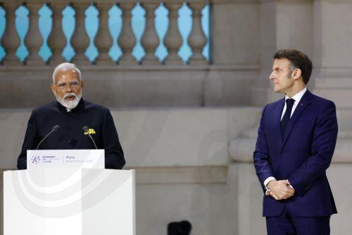 epa11888298 French President Emmanuel Macron (R) looks on as Indian Prime Minister Narendra Modi delivers his speech during a plenary session of the Artificial Intelligence (AI) Action Summit at the Grand Palais in Paris, France, 11 February 2025. The summit takes place from 10 to 11 February.  EPA/MOHAMMED BADRA