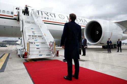 epa11890600 French President Emmanuel Macron looks on as Indian Prime Minister Narendra Modi boards a plane after a departure ceremony at Marseille Provence airport in Marignane as part of a visit in Marseille, France, 12 February 2025.  EPA/CHRISTIAN HARTMANN / POOL MAXPPP OUT
