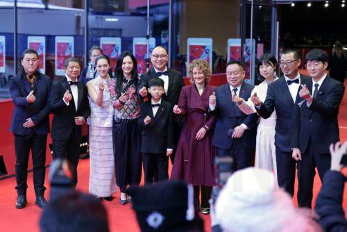 epa11895829 Sound designer Li Tiao (L), actor Zhang Chuwen (3-L), executive producer Yao Chen (4-L), actor Wang Shang (5-L), Chinese film director Huo Meng (C), Berlin International Film Festival Director Tricia Tuttle (C-R), executive producer Jiang Hao (4-R) and producer Zhang Fan (3-R) and other cast members attend the photocall for 'Sheng Xi Zhi Di...