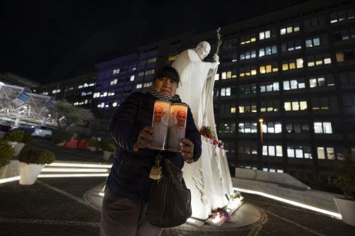 epa11905742 A woman lights candles during a prayer of the Bolivian community at the Gemelli Hospital where Pope Francis is hospitalized, Rome, 18 February 2025. Pope Francis was hospitalized on 14 February due to a respiratory tract infection. While his condition is showing signs of improvement, the hospitalized pontiff will not lead his weekly Angelus...