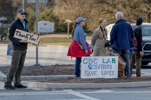 epa11906310 Richard Walker (L), whose wife works at the CDC, and other protesters greet employees with support as they leave work at the US Centers for Disease Control and Prevention (CDC) headquarters in Atlanta, Georgia, USA, 18 February 2025. The Trump administration has announced job cuts of nearly 1,300 probationary employees at the CDC, equal to about...