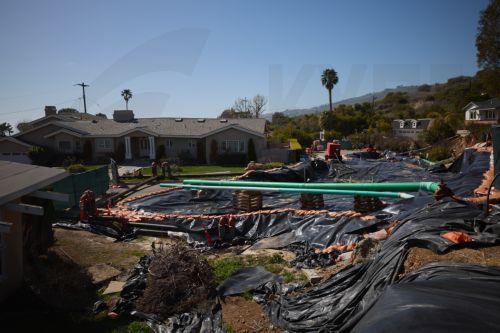 epa11984924 Houses sink into the ground and various utility pipes are moved above ground due to land movement in Rancho Palos Verdes, California, USA, 23 March 2025. The Palos Verdes Peninsula has been seeing a decades-long, slow-moving landslide that is pulling apart structures, cutting gas and power lines, and severing roads. According to NASA, the large...