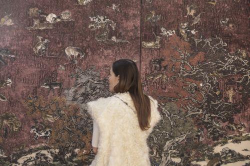 epa12004915 A woman observes part of the painting Tale of the Eleventh Day - Red by Chinese artist Yang Jiechang, displayed at the French gallery Jeanne Bucher Jaeger stand during the Art Paris fair at the Grand Palais in Paris, France, 02 April 2025. The modern and contemporary fair Art Paris runs from 03 to 06 April 2025 and hosts 170 galleries from 25...