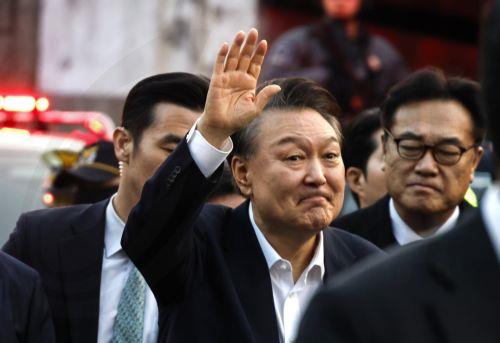 epa12008504 (FILE) - South Korea's impeached president Yoon Suk Yeol (C) waves to supporters as he arrives in front of his residence after being released from detention, in Seoul, South Korea, 08 March 2025 (issued 04 April 2025).The Constitutional Court upheld Yoonâ€™s impeachment on 04 April 2025, removing him from office over his brief imposition of...