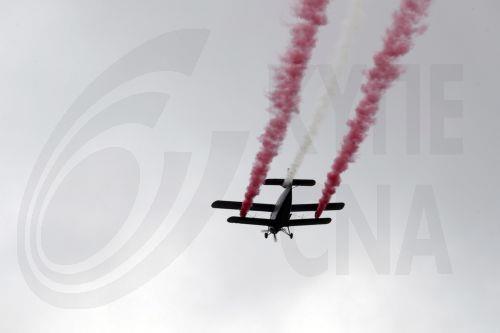 epa12072775 A Latvian Army An-2 aircraft releases smoke in the colors of the Latvian flag during the Latvian Independence Restoration Day military parade in Talsi, Latvia, 04 May 2025. The day marks a national holiday celebrated annually with the traditional military parade taking place in a different regional center since 2013.  EPA/TOMS KALNINS
