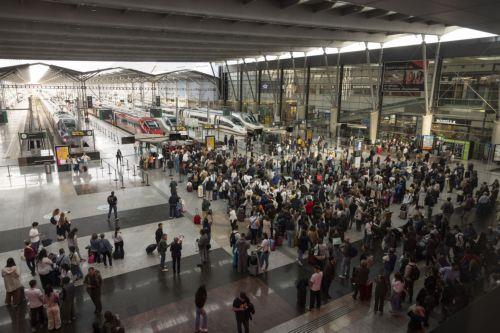 epa12074405 Passengers wait near high-speed trains bound for Madrid at Maria Zambrano station in Malaga, Spain, 05 May 2025, after the train connection between Andalucia region and Madrid was interrupted the previous day due to the theft of cable at several points. According to Transport Minister Oscar Puente, the connection will be reestablished at 9.30 am...