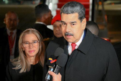 epa12079158 A handout photo made available by Photo host Agency RIA Novosti shows Venezuelan President Nicolas Maduro (R) accompanied by his wife Cilia Flores (L), speaking with journalists upon his arrival at Vnukovo airport to attend the celebrations to mark this year's 80th anniversary of Russia's Victory in the Great Patriotic War of 1941-1945, in...
