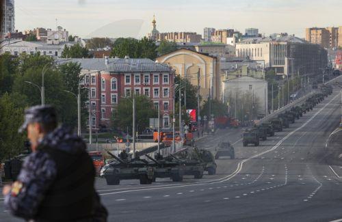 epa12079163 A Russian policeman stands guard as military vehicles arrive for the general rehearsal of the annual military parade ahead of Victory Day celebrations, in downtown Moscow, Russia, 07 May 2025. Russia is preparing to mark the 80th anniversary of Nazi Germany's unconditional surrender in World War II (WWII). The military parade will take place in...