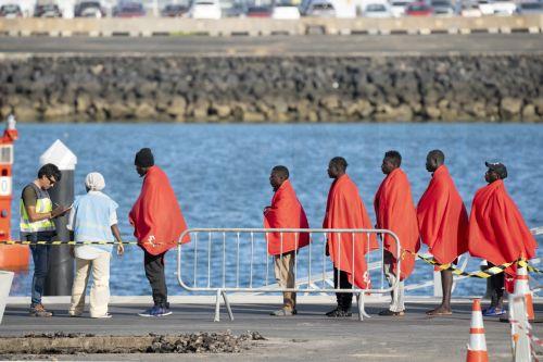 epa12084659 Sub-Saharan migrants disembark a boat in Port of Arrecife, Canary Islands, Spain, 08 May 2025. The Guardamar Polimnia, a maritime rescue vessel, rescued 88 people in distress on two boats.  EPA/Adriel Perdomo