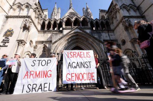 epa12095684 Protesters carry banners as they demonstrate against selling arms to Israel at the Royal Courts of Justice in London, Britain, 13 May 2025. A four-day judicial review brought by Palestinian rights group Al-Haq and the Global Legal Action Network (GLAN) starts in the High Court on 13 May, with human rights' groups and lawyers arguing that UK's...