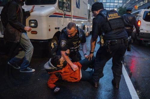 epa12142274 Two DHS officers restrain a protester after tackling her to the ground during an immigration protest outside the Varick Street ICE facility in Manhattan, New York, USA, 28 May 2025. Migrants and US citizens were reportedly detained as President Trump's return to the White House sparked renewed immigration crackdowns.  EPA/OLGA FEDOROVA