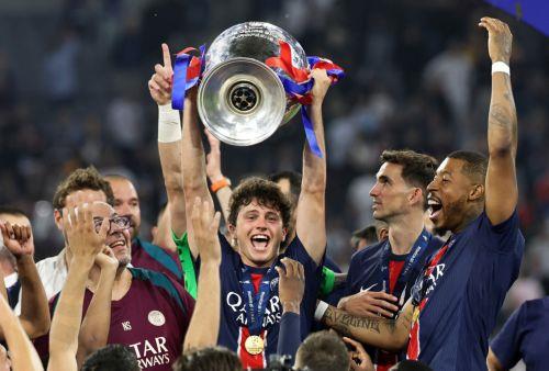 epaselect epa12148428 Joao Neves of PSG celebrates with the trophy after the UEFA Champions League final between Paris Saint-Germain and Internazionale Milano in Munich, Germany 31 May 2025. PSG won 5-0.  EPA/RONALD WITTEK