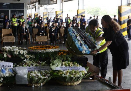 epa12169700 A representative from the Israeli Embassy in Thailand (R) laid a wreath in mourning next the coffin of Thai worker Nattapong Pinta, who was taken hostage in the Hamas-led 07 October 2023 attacks on Israel, after the body was repatriated to Thailand, at Suvarnabhumi Airport in Samut Prakan province, Thailand, 11 June 2025. Thailand's Ministry of...