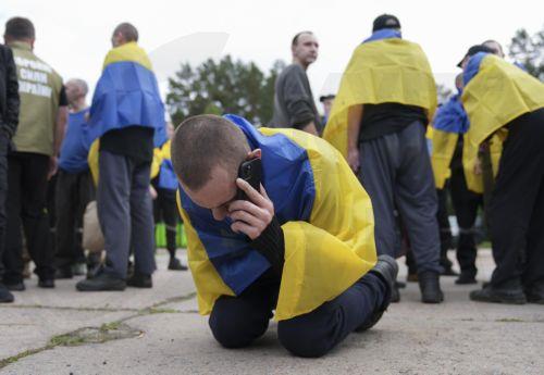 epa12171808 A Ukrainian prisoners of war (POWs) makes a phone call following a prisoner swap at an undisclosed location in Ukraine, 12 June 2025. This is the second stage of the return of seriously wounded and seriously ill soldiers, Ukrainian President Volodymyr Zelensky wrote in his official Telegram channel. The agreement on a POW exchange was reached...