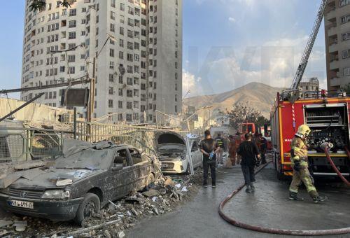 epaselect epa12172720 Fire fighters work outside a building that was hit by Israeli air strikes north of Tehran, Iran, 13 June 2025. Israel confirms it has launched strikes on Iran's 'nuclear program' as blasts are heard across the country. The strikes are part of Operation Rising Lion, Israel's Prime Minister Benjamin Netanyahu said, adding Iran was a...