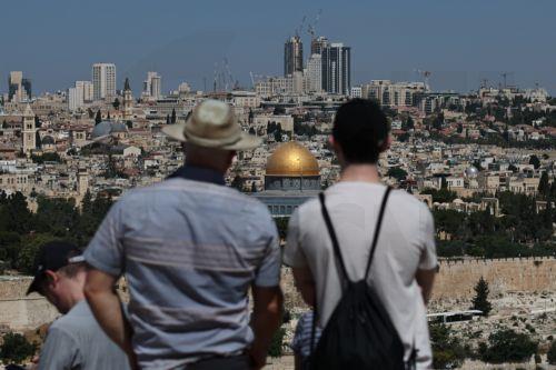 epaselect epa12172995 People look at the Dome of the Rock in the Al Aqsa compound in Jerusalem's old city, 13 June 2025. Israelâ€™s Home Front Command announced on 13 June the enforcement of a stricter defense policy, including â€œprohibition on educational activities, gatherings, and workplaces, except for essential sectorsâ€, following early morning...