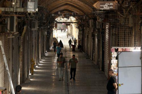 epa12178739 People walk inside the closed Grand Bazaar in Tehran, Iran, 16 June 2025. Israel and Iran have been exchanging fire since Israel launched strikes across Iran on 13 June 2025 as part of Operation 'Rising Lion.'  EPA/ABEDIN TAHERKENAREH