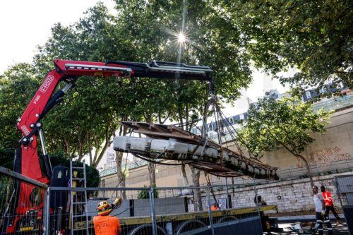 epa12185030 Workers operate heavy machinery on the construction site of the future Grenelle swimming site on the Seine River bank, in the Port de Grenelle, near the Eiffel Tower, in Paris, France, 19 June 2025. Parisians will be able to swim in the Seine river from 05 July until 31 August 2025, with three swimming sites preparing to open for the public as...
