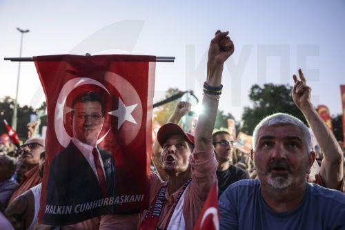 epa12209312 People hold pictures of Ekrem Imamoglu as they take part in a rally organized by the country's main opposition Republican People's Party (CHP) against the suspension and imprisonment of Istanbul Mayor Ekrem Imamoglu, in front of the Istanbul Municipality in Istanbul, Turkey, 01 July 2025. Imamoglu, of the Republican People's Party, was jailed...
