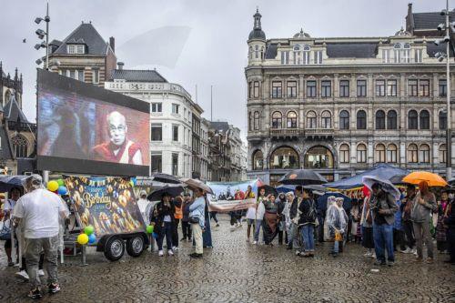 epa12220379 People gather on Dam Square to celebrate the 90th birthday of the Dalai Lama, in Amsterdam, the Netherlands, 06 July 2025. The Tibetan Buddhist spiritual leader, born in 1935, turns 90 years old on 06 July 2025.  EPA/DINGENA MOL