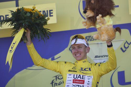 epa12232026 Slovenian rider Tadej Pogacar of UAE Team Emirates celebrates on the podium wearing the overall leader's yelllow jersey after the 7th stage of the Tour de France cycling race over 197km from Saint Malo to Mur-de-Bretagne, France, 11 July 2025.  EPA/MARTIN DIVISEK