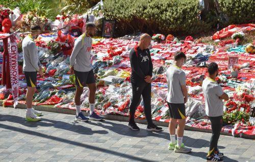 epa12232242 Liverpool players with head coach Arne Slot (C, black tracksuit) view tributes to late Portuguese soccer player Diogo Jota at Anfield, the home of Liverpool FC, in Liverpool, Britain, 11 July 2025. Jota died in a car accident in Spain together with his brother Andre Silva on 03 July 2025.  EPA/PETER POWELL