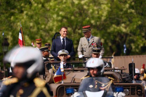 epa12237079 French President Emmanuel Macron stands in the command car with Chief of Staff of the French Armed Forces (CEMA) Thierry Burkhard during the annual Bastille Day military parade in Paris, France, 14 July 2025. France celebrates its national holiday, or Bastille Day, annually on 14 July to commemorate the storming of the Bastille fortress in 1789....