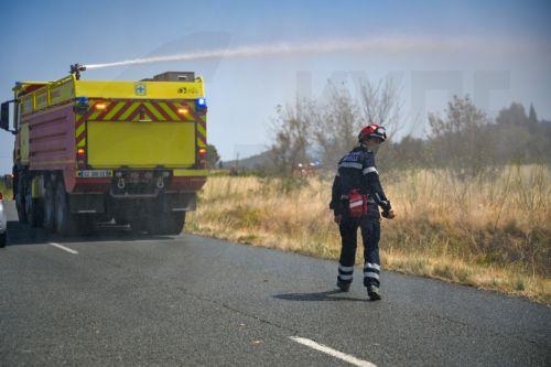 epaselect epa12288125 A firefighting crew is deployed to tackle a brush fire as a wildfire continues to spread in Saint-Laurent-de-la-Cabrerisse, Aude department, southern France, 07 August 2025. Some 16,000 hectares have been burned so far and at least one person died in one of the biggest wildfires in France since 1949.  EPA/PHILIPPE MAGONI