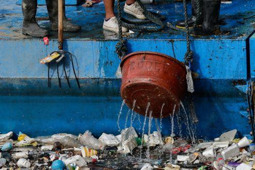 epa12311487 Workers from city environment and sanitation services collect trash and debris from a creek during a clean-up operation at the boundary of San Juan and Quezon City, Metro Manila, Philippines, 20 August 2025. Almost two consecutive weeks of typhoon and heavy monsoon rains in the month of July triggered massive flooding in Metro Manila and several...