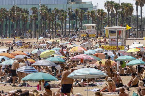 epa12316541 Beach-goers sunbathe near a closed lifeguard station on Barceloneta Beach as lifeguards protest for better working conditions in Barcelona, northeastern Spain, 22 August 2025. Barcelona's lifeguards are on a strike since 01 August 2025.  EPA/Quique Garcia