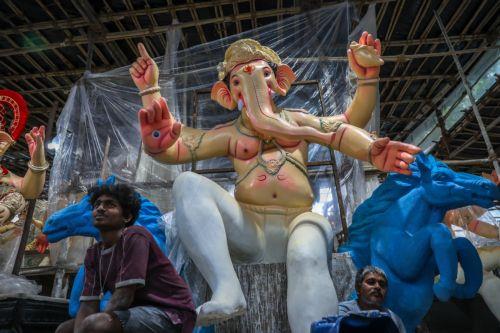 epa12316729 An artist works on an idol of elephant-headed Hindu God Lord Ganesha for the upcoming Ganesha Festival, at a workshop in Mumbai, India, 22 August 2025. The Ganesha Festival, also known as Ganesha Chaturthi, celebrates the birthday of the Hindu god Lord Ganesha. Observed in the Hindu calendar month of Bhadrapada, this year's festival runs from 27...