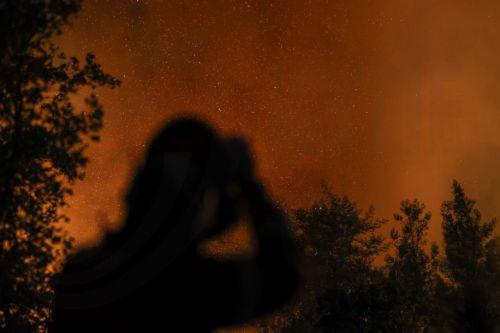 epa12319175 Firefighters battle a forest fire in Pedrogao Grande, Leiria, Portugal, 23 August 2025. The two fires that are currently consuming forest in Pedrogao Grande have already reached the municipality of Serta, with various resources being deployed in both areas to combat the fire, the Civil Protection said.  EPA/PAULO NOVAIS  EPA/PAULO NOVAIS