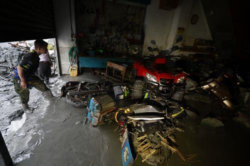 epa12401274 A man looks at the flooded interior of a building in the aftermath of Super Typhoon Ragasa in Guangfu Township, Hualien County, Taiwan, 24 September 2025. At least 14 people have died, 32 were injured and more than 150 are missing in the eastern county after a barrier lake in the mountains overflowed and inundated the township during the...