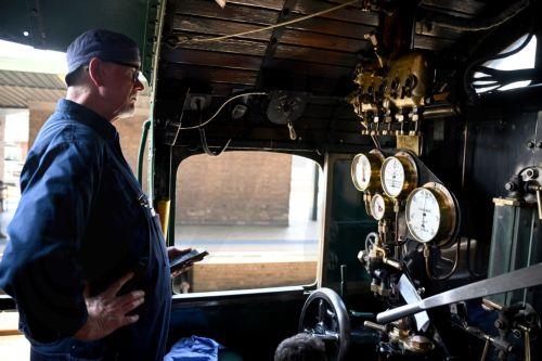 epa12406659 Driver Alex Claassens prepares the 3526 steam locomotive ahead of its departure from Central Station in Sydney, Australia, 26 September 2025. Friday, 26 September 2025 marks 170 years since New South Wales launched its first passenger railway line, connecting Sydney and Parramatta.  EPA/DAN HIMBRECHTS AUSTRALIA AND NEW ZEALAND OUT