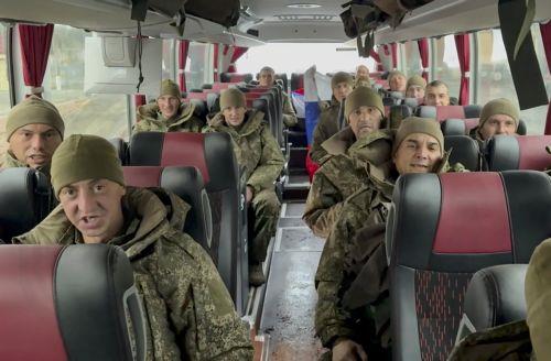 epa12423724 A still image taken from a handout video made available by the Press Service of the Russian Ministry of Defence shows Russian servicemen sitting in a bus after being released in a prisoners swap between Russia and Ukraine, at an undisclosed location in Belarus, 02 October 2025. The Russian Defense Ministry announced that as a result of a...