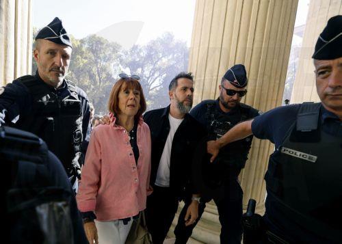 epa12434711 Gisele Pelicot (2-L), accompanied by her son Florian Pelicot (C), arrives at the Gard criminal court, in Nimes, France, 06 October 2025. An appeal trial involving one of the defendants sentenced in the mass rapes committed against her will be heard by the court from 06 through 09 October.  EPA/GUILLAUME HORCAJUELO