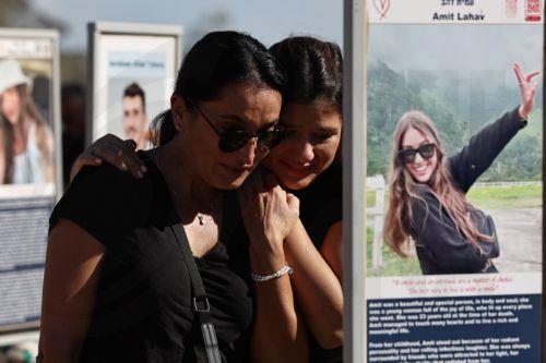 epa12436543 Israeli family members visintg the memorials at the site of the Nova music festival, near Re'im, on the second anniversary of the 07 October 2023 Hamas attacks, near the Gaza border, southern Israel, 07 October 2025. October 07 marks two years since the Palestinian militant group Hamas launched a surprise attack on Israel, taking dozens of...