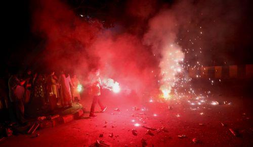 epa12468324 People light sparklers and crackers during Diwali celebrations near New Delhi, India, 20 October 2025. Diwali, the Hindu festival of lights symbolizing the victory of good over evil and marking Lord Rama's return to Ayodhya after 14 years of exile, is celebrated with fireworks. However, the celebrations severely impact Delhi's air quality, with...