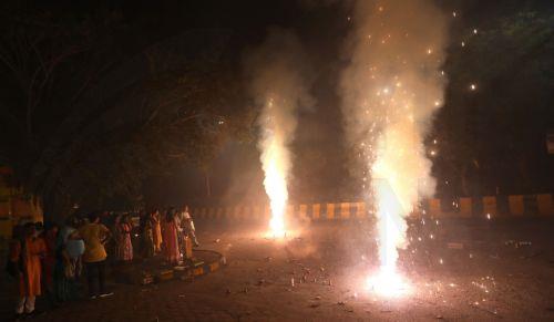 epa12468325 People light sparklers and crackers during Diwali celebrations near New Delhi, India, 20 October 2025. Diwali, the Hindu festival of lights symbolizing the victory of good over evil and marking Lord Rama's return to Ayodhya after 14 years of exile, is celebrated with fireworks. However, the celebrations severely impact Delhi's air quality, with...