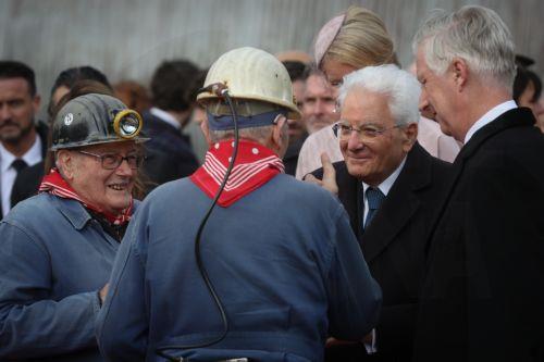 epa12469766 Italy's President Sergio Mattarella (2-R) and King Philippe (R) of Belgium speak with old miners during a visit to the Bois du Cazier, a former coal mine in the Marcinelle district of Charleroi, Belgium, 21 October 2025, as part of a state visit. On 08 August 1956, a major mining disaster occurred at the Bois du Cazier coal mine, killing 262...