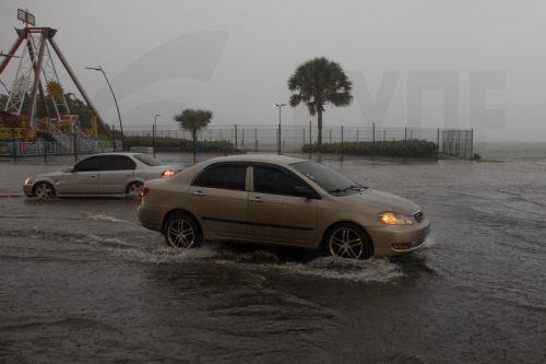 epa12471601 Vehicles travel through a flooded street in Santo Domingo, Dominican Republic, 21 October 2025. The Dominican Republic activated emergency plans in response to heavy rainfall forecast from Tropical Storm Melissa, which formed in the Caribbean Sea and triggered warnings for the Dominican Republic, Haiti, and Jamaica.  EPA/ORLANDO BARRIA