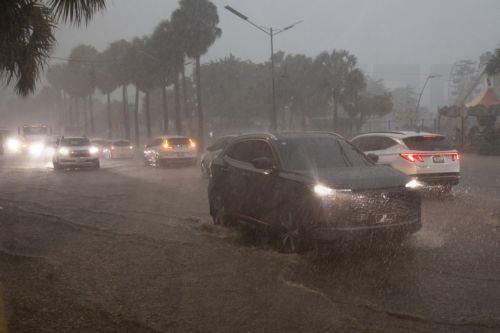 epa12471605 Vehicles travel through a flooded street in Santo Domingo, Dominican Republic, 21 October 2025. The Dominican Republic activated emergency plans in response to heavy rainfall forecast from Tropical Storm Melissa, which formed in the Caribbean Sea and triggered warnings for the Dominican Republic, Haiti, and Jamaica.  EPA/ORLANDO BARRIA