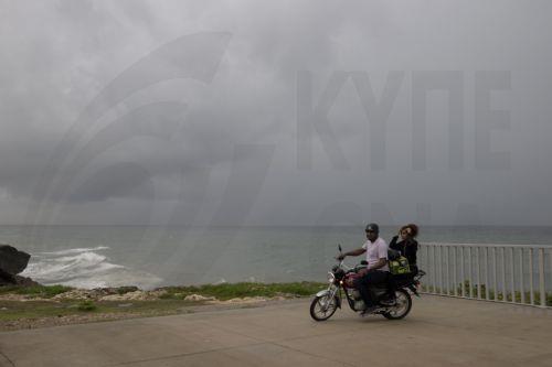 epa12471606 People transit in Santo Domingo, Dominican Republic, 21 October 2025. The Dominican Republic activated emergency plans in response to heavy rainfall forecast from Tropical Storm Melissa, which formed in the Caribbean Sea and triggered warnings for the Dominican Republic, Haiti, and Jamaica.  EPA/ORLANDO BARRIA