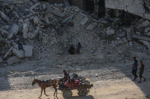 epa12475840 Palestinians move among the rubble of destroyed buildings in the heavily damaged Sheikh Redwan neighborhood of Gaza City, 23 October 2025. The ceasefire between Israel and Hamas that is currently in place is part of the first phase of a Gaza peace plan that includes a halt in fighting, the release of hostages and prisoners, and the delivery of...