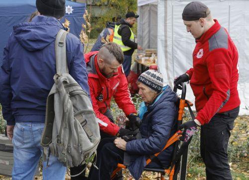 epa12483430 Medical workers assist an elderly woman near the site of a Russian strike in Kyiv, Ukraine, 26 October 2025, amid the Russian invasion. At least three people were killed and more than 30 others injured, including seven children, after Russian forces launched an overnight attack on Kyiv, the National Police of Ukraine reported.  EPA/SERGEY...