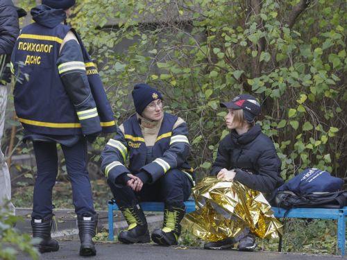 epa12483434 Ukrainian psychologists assist a child near the site of a Russian strike in Kyiv, Ukraine, 26 October 2025, amid the Russian invasion. At least three people were killed and more than 30 others injured, including seven children, after Russian forces launched an overnight attack on Kyiv, the National Police of Ukraine reported.  EPA/SERGEY...