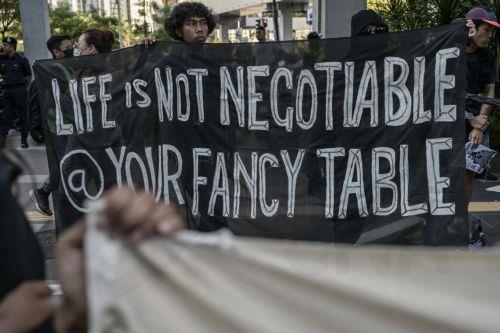 epa12483628 Protesters display a banner during a protest rally against US President Donald Trump's visit to Malaysia to attend the Association of Southeast Asian Nations (ASEAN) Summit at Ampang Park in Kuala Lumpur, Malaysia, 26 October 2025. Protesters gathered to oppose President Trump’s visit for the 47th ASEAN Summit.  EPA/AFFAN FAUZI