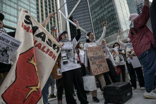 epa12483632 Protesters display placards during a protest rally against US President Donald Trump's visit to Malaysia to attend the Association of Southeast Asian Nations (ASEAN) Summit at Ampang Park in Kuala Lumpur, Malaysia, 26 October 2025. Protesters gathered to oppose President Trump’s visit for the 47th ASEAN Summit.  EPA/AFFAN FAUZI